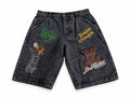 Short en jean noir délavé avec patchs brodés colorés