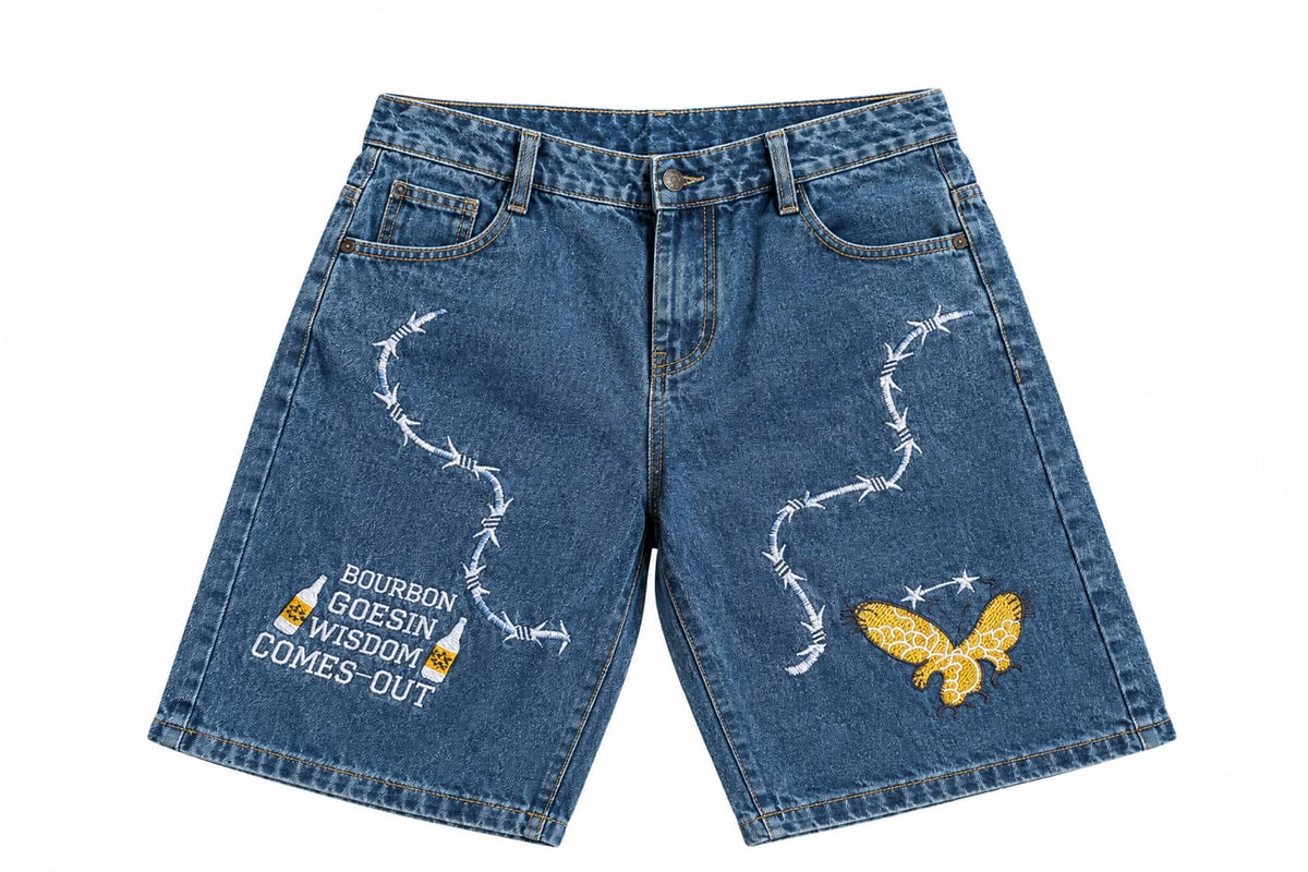 Short en jean bleu avec broderies blanches barbelé et patch aigle doré